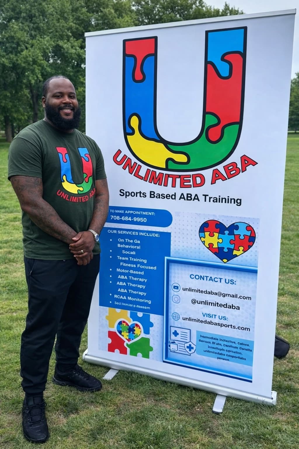 Basim Hudeen, owner of Unlimited ABA Sports, beside his clinic banner